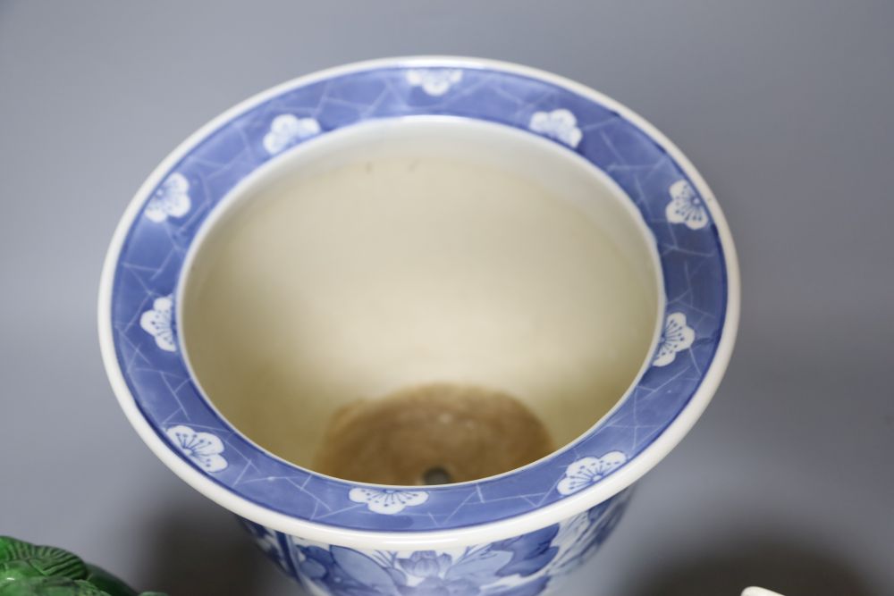 A Chinese blue and white jardiniere, a green glazed lion dog and a famille rose dish